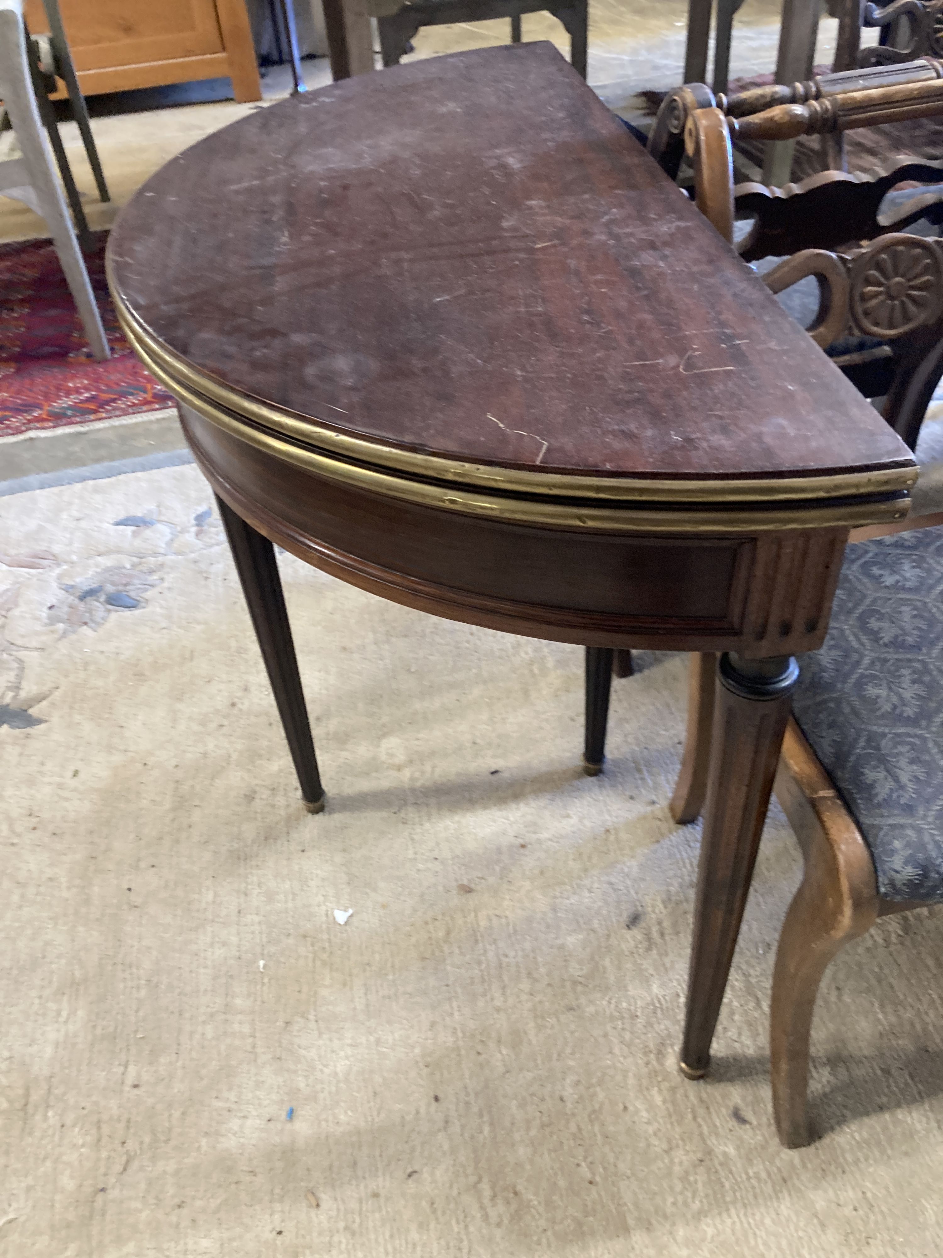 An early 20th century French brass mounted mahogany D shape folding card table, width 91cm, depth 46cm, height 75cm